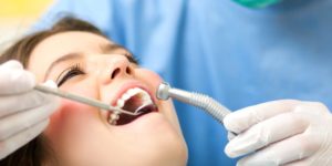 periodontist examining woman's teeth